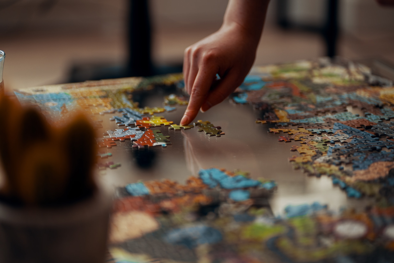 Image of a person adjusting puzzle pieces coming together.